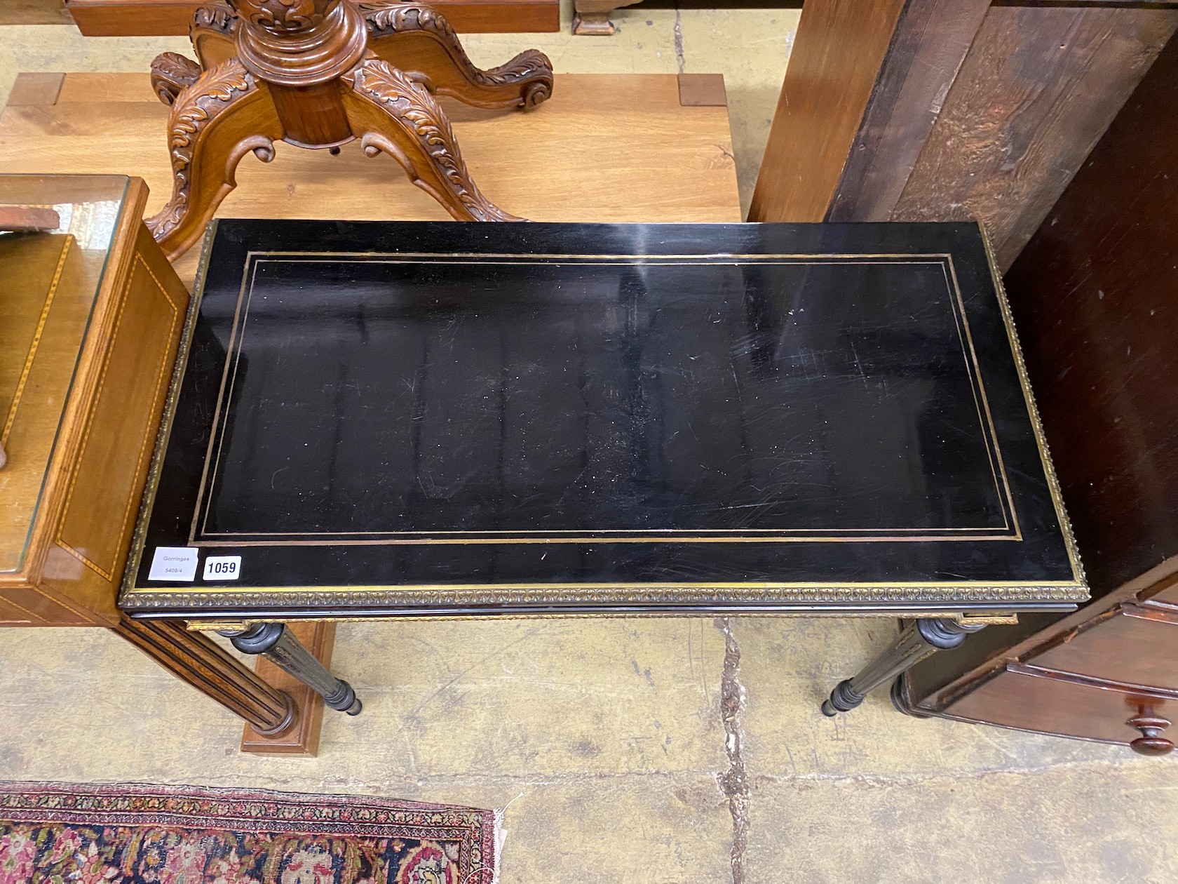 A late 19th century French gilt metal mounted ebonised rectangular folding card table, width 90cm, depth 45cm, height 76cm